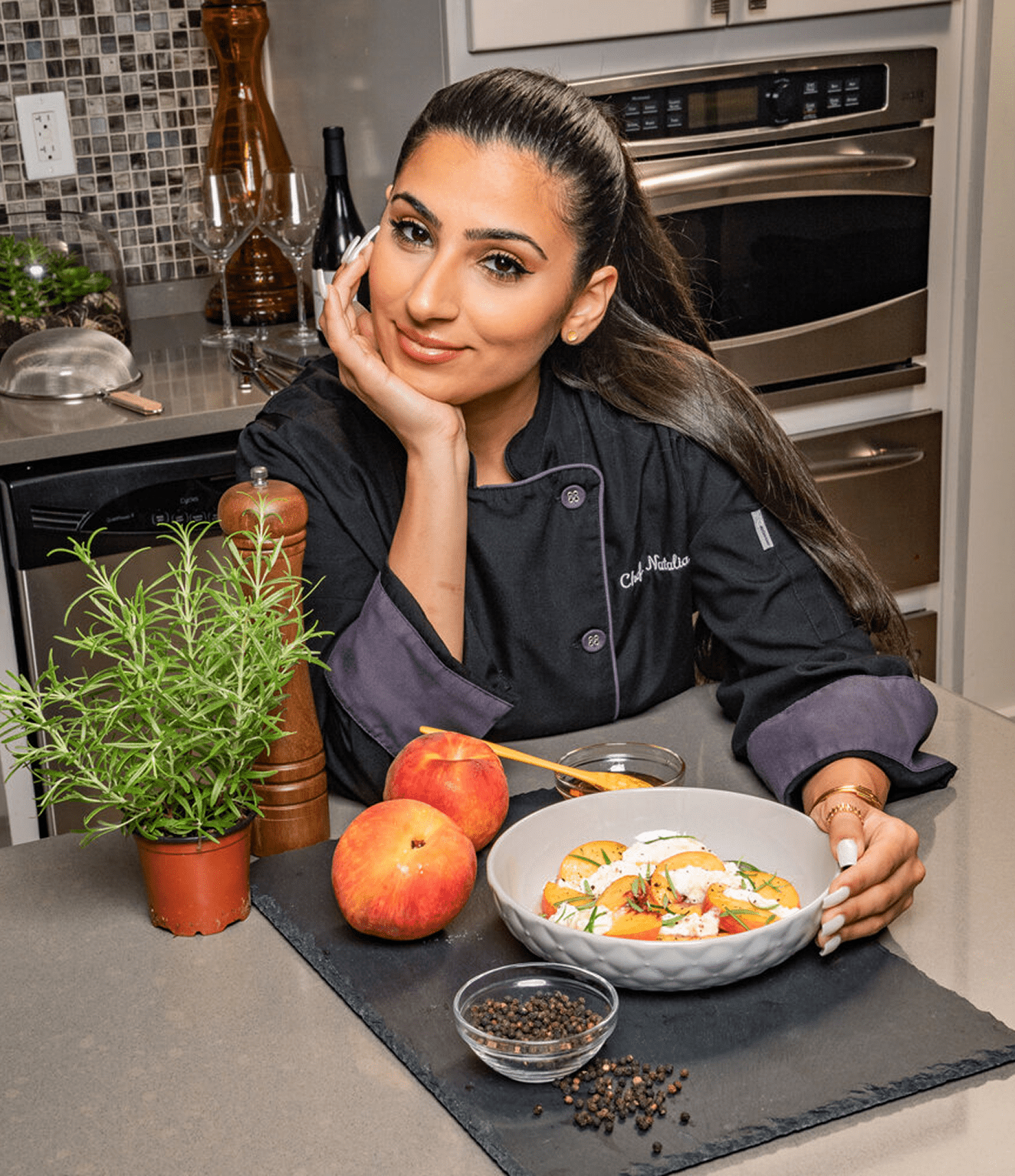 Chef posing with salad and peaches.